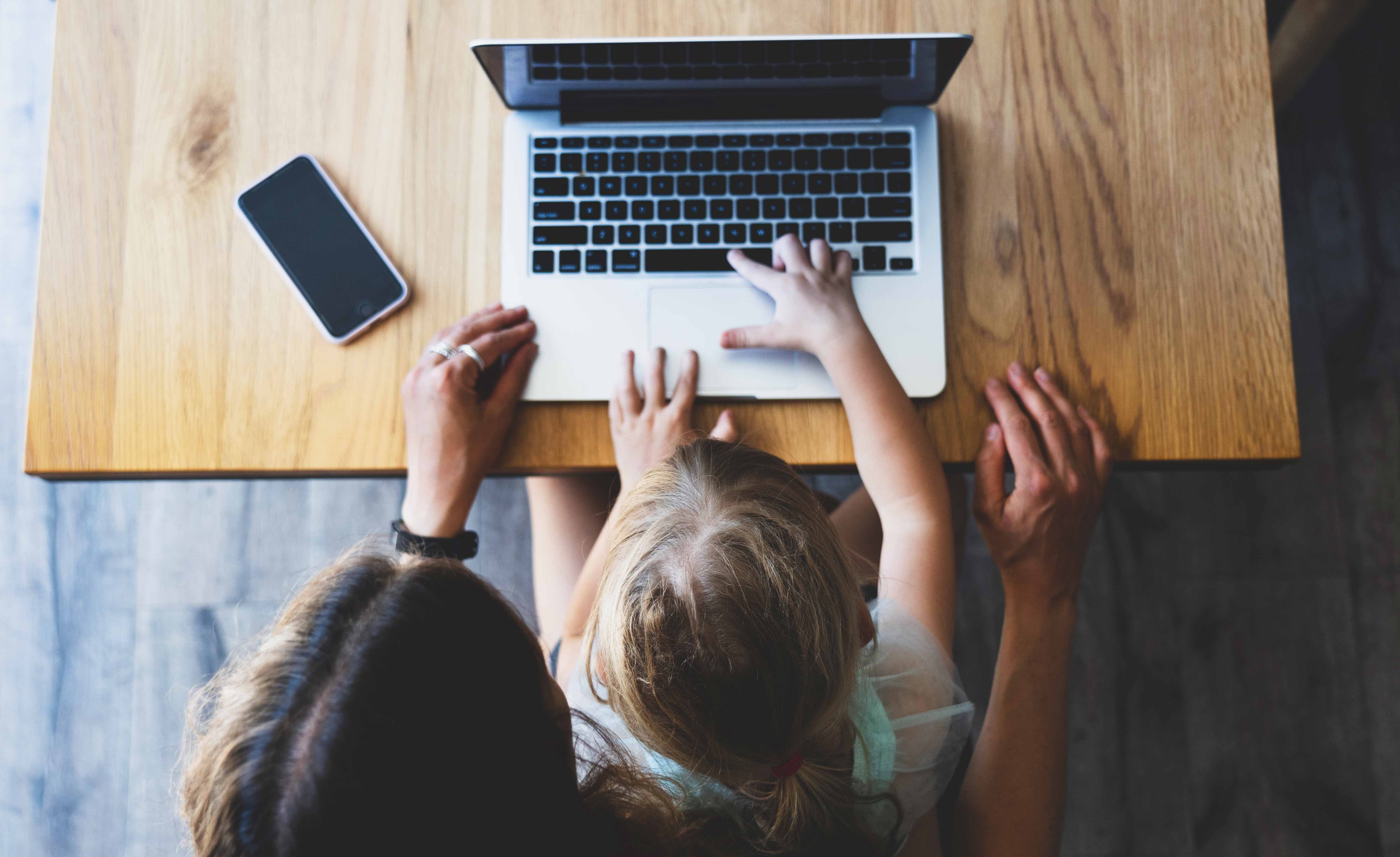 Mom & child sitting together on the Internet